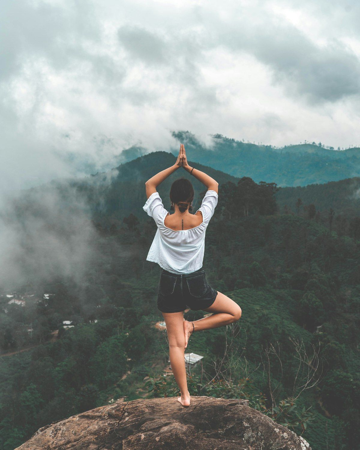 Yoga instructor adjusting a pose in soft morning light